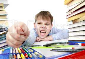 boy behind a table with books