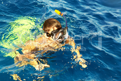 boy floats in the sea