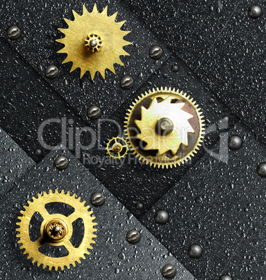 Gold gears against ferrous metal