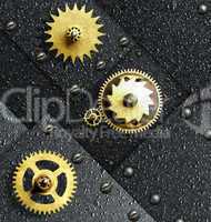 Gold gears against ferrous metal