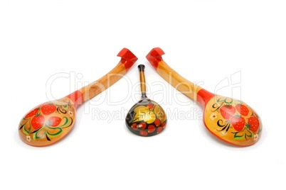 Three wooden Russian hand-painted spoons on white background