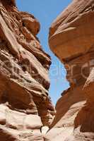 Narrow slot between two rocks in desert canyon