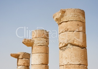 Three broken column tops of ancient temple