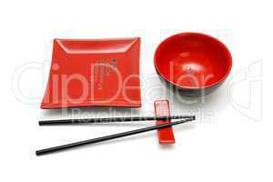 Square red plate, round bowl and chopsticks on stand