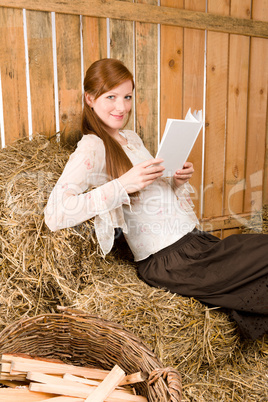 Young romantic woman read book in barn