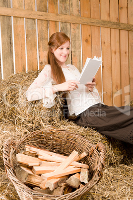 Young romantic woman read book in barn