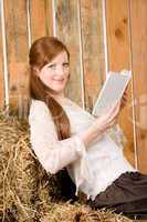 Young romantic woman in barn hold book