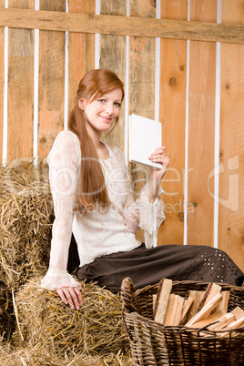 Young romantic woman read book in barn