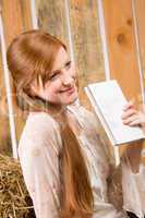 Young romantic woman hold book in barn