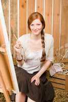 Red-hair romantic woman in barn painting country