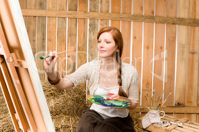 Red-hair romantic woman in barn painting country