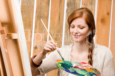 Red-hair romantic woman in barn painting country