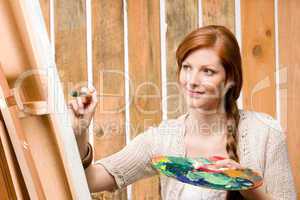 Red-hair romantic woman in barn painting country