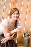 Young woman drink natural milk in barn