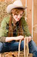 Young cowgirl western country style with rope