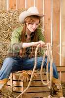 Young cowgirl western country style with rope