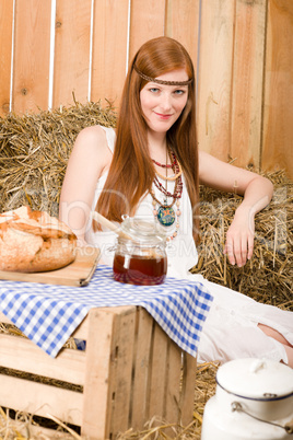 Redhead hippie woman have breakfast in barn