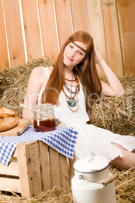 Redhead hippie woman have breakfast in barn