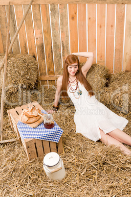 Redhead hippie woman have breakfast in barn