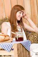 Red-hair young hippie woman breakfast in barn