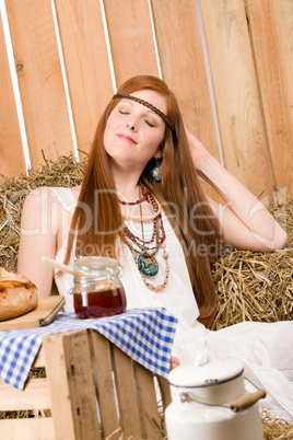 Red-hair young hippie woman breakfast in barn