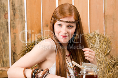 Red-hair hippie woman have breakfast in barn