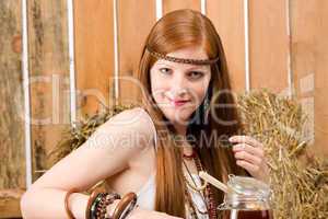 Red-hair hippie woman have breakfast in barn