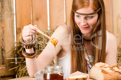 Red-hair young hippie woman have breakfast in barn