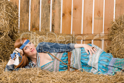 Young hippie woman lying on hay relax