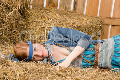 Young hippie woman lying on hay relax