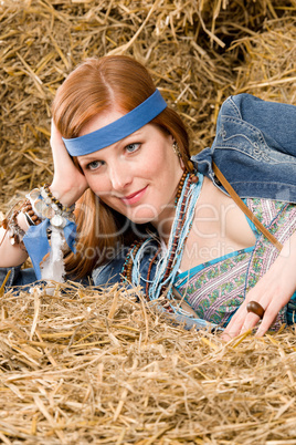 Young hippie woman lying on hay relax