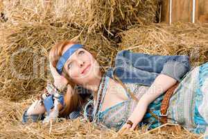 Young hippie woman lying on hay relax