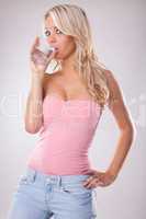 Young woman with fresh cold water in glass