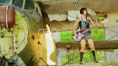 Girl stands with a guitar