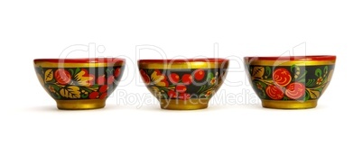 Three painted Russian khokhloma wooden cups isolated