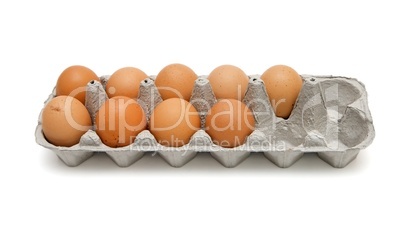 Nine brown eggs in a paper box isolated