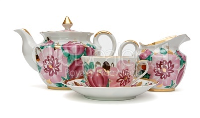 Old-fashioned tea service with floral pattern isolated