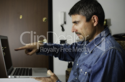 Man Working inside with his Laptop