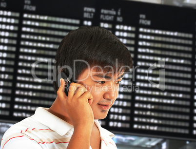 Man Talking On His Mobile Phone In An Airport