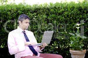 Business Man Working Outside with his Laptop