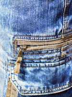 close-up of denim trousers with patch pockets with zip