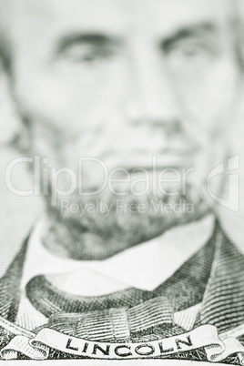 Close up of President Lincoln on five dollar bill