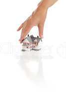 Womans Hand Choosing A Home on White