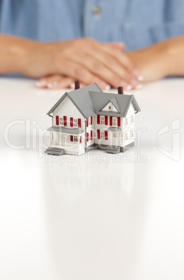 Womans Folded Hands Behind Model House