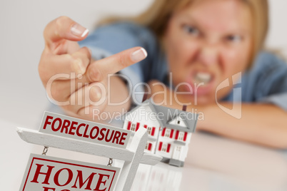 Woman Flipping The Bird Behind Model Home and Foreclosure Sign