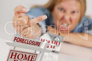 Woman Flipping The Bird Behind Model Home and Foreclosure Sign