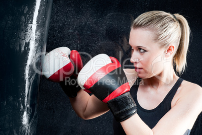 Boxing training woman with punching bag in gym