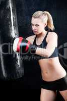 Boxing training woman in gym punching bag