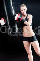 Boxing training woman hold punching bag portrait