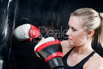 Boxing training woman with punching bag in gym